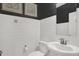 Modern powder room featuring white subway tile, dark paint, and stylish sink at 5311 Pelion Pl, McCordsville, IN 46055