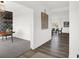 Hallway leading to a dining space and study, featuring hardwood floors and neutral colored walls at 5311 Pelion Pl, McCordsville, IN 46055