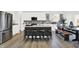 Spacious kitchen featuring an island with seating, stainless steel appliances, and a dining area with an outdoor view at 5311 Pelion Pl, McCordsville, IN 46055