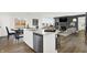 Open kitchen showcasing an island with seating, stainless steel appliances, and an open concept living space at 5311 Pelion Pl, McCordsville, IN 46055