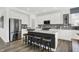 Stylish kitchen featuring an island with seating, stainless steel appliances, and bright white cabinets at 5311 Pelion Pl, McCordsville, IN 46055