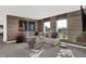 Bright living room featuring a comfortable sectional, wood accent wall, and view of the backyard at 5311 Pelion Pl, McCordsville, IN 46055