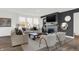 Bright living room featuring a fireplace, dark accent wall, modern furniture, and a large window with a nature view at 5311 Pelion Pl, McCordsville, IN 46055