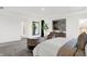 Bright main bedroom features stylish furnishings, a leafy tree, and natural lighting at 5311 Pelion Pl, McCordsville, IN 46055