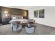 Bright main bedroom boasts elegant furnishings, including a comfortable seating area and a large accent wall at 5311 Pelion Pl, McCordsville, IN 46055