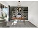 Sunlit study showcasing a work desk, geometric print wall, shelving, and bright neutral walls at 5311 Pelion Pl, McCordsville, IN 46055