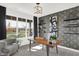 Brightly lit study features a wooden desk, pendant lighting, and a large window offering natural light at 5311 Pelion Pl, McCordsville, IN 46055