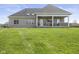 Expansive backyard featuring a covered patio and lush green lawn, perfect for outdoor entertaining at 5348 Ashby Ct, Greenwood, IN 46143