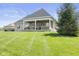Spacious backyard with well-manicured lawn and a cozy covered patio, ideal for relaxation and outdoor living at 5348 Ashby Ct, Greenwood, IN 46143