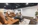 Large basement with comfortable seating, concrete floors, and a dark ceiling, offering ample space for various activities at 5348 Ashby Ct, Greenwood, IN 46143