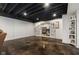 Open basement space featuring concrete floors and black ceiling with easy access to the home office at 5348 Ashby Ct, Greenwood, IN 46143