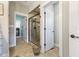 The bathroom leads to the laundry room and has a tiled, glass-enclosed shower at 5348 Ashby Ct, Greenwood, IN 46143