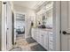 Bathroom with double vanity sinks, granite countertop, and linen cabinets offers style and storage at 5348 Ashby Ct, Greenwood, IN 46143