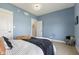 Blue bedroom with warm colored throw blanket and decorative pillows on a large bed at 5348 Ashby Ct, Greenwood, IN 46143