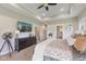 Bright bedroom features a tray ceiling, ceiling fan, dresser, mirror and neutral color palette at 5348 Ashby Ct, Greenwood, IN 46143