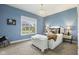 Blue bedroom with window view, plush furnishings and white accents and rug at 5348 Ashby Ct, Greenwood, IN 46143