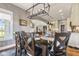 Elegant dining room with a view of the living area and kitchen, showcasing natural light and stylish decor at 5348 Ashby Ct, Greenwood, IN 46143