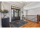 Inviting foyer with hardwood floors, a decorative rug, and a dark wood front door with glass panels at 5348 Ashby Ct, Greenwood, IN 46143