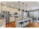 Open kitchen with granite countertops, stainless steel appliances, island, and dining area access at 5348 Ashby Ct, Greenwood, IN 46143