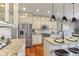 A well-lit kitchen with granite countertops, stainless steel appliances, and a functional center island at 5348 Ashby Ct, Greenwood, IN 46143