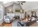Comfortable living room with a fireplace, vaulted ceiling, skylights, hardwood floors, and an open layout at 5348 Ashby Ct, Greenwood, IN 46143