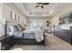 Spacious main bedroom featuring a tray ceiling, bedside tables, and a ceiling fan at 5348 Ashby Ct, Greenwood, IN 46143