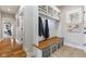 The mudroom has a wood bench with storage baskets and hooks for coats and jackets at 5348 Ashby Ct, Greenwood, IN 46143