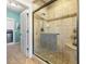 This bathroom has a spacious shower with glass doors and a built-in bench at 5348 Ashby Ct, Greenwood, IN 46143