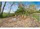 Outdoor gathering area with a fire pit, Adirondack chairs, and gravel surround, perfect for enjoying outdoors at 575 Everling Dr, Morgantown, IN 46160