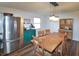 Bright dining room with stainless steel refrigerator, wood table, and chairs, perfect for Gathering meals at 575 Everling Dr, Morgantown, IN 46160