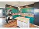 Well-equipped kitchen with green cabinetry, stainless steel appliances, an island, and modern fixtures at 575 Everling Dr, Morgantown, IN 46160