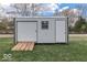 Exterior view of a white storage shed with roll up door and side door at 575 Everling Dr, Morgantown, IN 46160