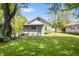 A grassy backyard with a view of the house, enclosed by a black metal fence at 5817 Beechwood Ave, Indianapolis, IN 46219