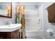 Bathroom features a combined shower and tub with a decorative shower curtain and towel rack at 5817 Beechwood Ave, Indianapolis, IN 46219