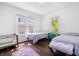 Spacious bedroom with two beds, a wooden floor, and multiple windows for natural light at 5817 Beechwood Ave, Indianapolis, IN 46219