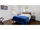 Bright bedroom with hardwood floors, featuring a comfortable bed and natural light at 5817 Beechwood Ave, Indianapolis, IN 46219