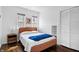 Bright bedroom with modern decor, hardwood floors, and white wainscoting at 5817 Beechwood Ave, Indianapolis, IN 46219