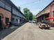 An inviting courtyard with a mix of brick and gray buildings, picnic tables, and string lights at 5817 Beechwood Ave, Indianapolis, IN 46219