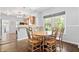 Cozy dining area with a wooden table, chairs, and views of the backyard at 5817 Beechwood Ave, Indianapolis, IN 46219
