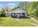 Charming bungalow-style home featuring a well-manicured lawn and inviting yellow front door at 5817 Beechwood Ave, Indianapolis, IN 46219