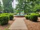 A picturesque fountain surrounded by lush greenery and a paved walkway in a tranquil park setting at 5817 Beechwood Ave, Indianapolis, IN 46219
