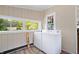 A laundry room featuring a modern washer and dryer set, natural light, and view to yard at 5817 Beechwood Ave, Indianapolis, IN 46219
