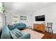 Bright living room with plush blue sofas, hardwood floors, and ample natural light at 5817 Beechwood Ave, Indianapolis, IN 46219