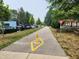 A scenic pathway lined with trees, parked cars, benches, and tables, offering a pleasant outdoor experience at 5817 Beechwood Ave, Indianapolis, IN 46219
