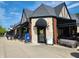 The exterior of a commercial building featuring multiple storefronts, outdoor seating, and pedestrian-friendly sidewalks at 5817 Beechwood Ave, Indianapolis, IN 46219