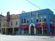 A bustling street view featuring the Irving and Antique Mall buildings, with shops and traffic lights at 5817 Beechwood Ave, Indianapolis, IN 46219