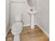 Powder room featuring a pedestal sink, oval mirror, and neutral paint at 5964 Lomita Ave, Plainfield, IN 46168
