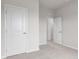 Neutral bedroom featuring carpet, white walls, white trim, and multiple doors at 5964 Lomita Ave, Plainfield, IN 46168
