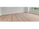 Bright bedroom featuring light wood flooring and a large window offering scenic outdoor views at 5964 Lomita Ave, Plainfield, IN 46168
