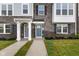 Charming townhome exterior featuring stone accents, two-story facade, and inviting front doors at 5964 Lomita Ave, Plainfield, IN 46168